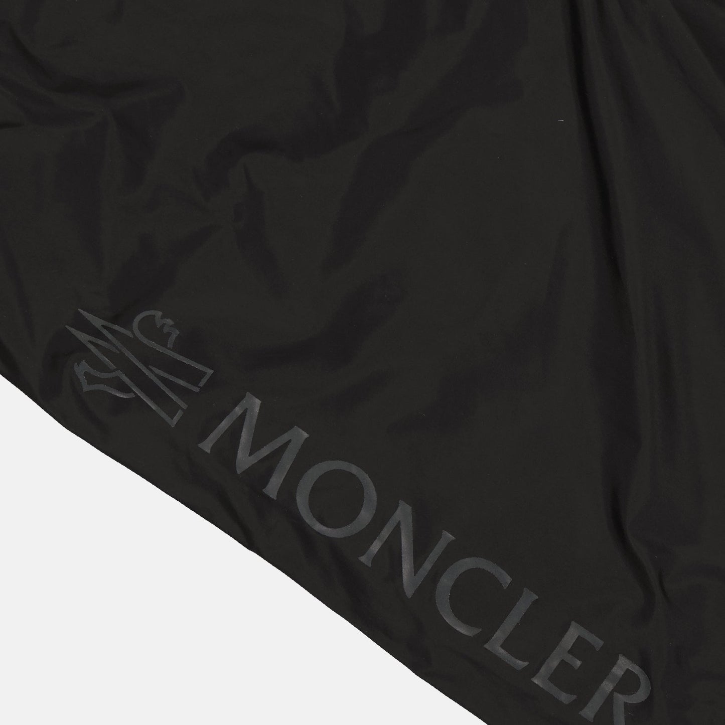 Moncler swim shorts, luxury swimwear, men's designer swimwear, black logo swim shorts, high-end beachwear