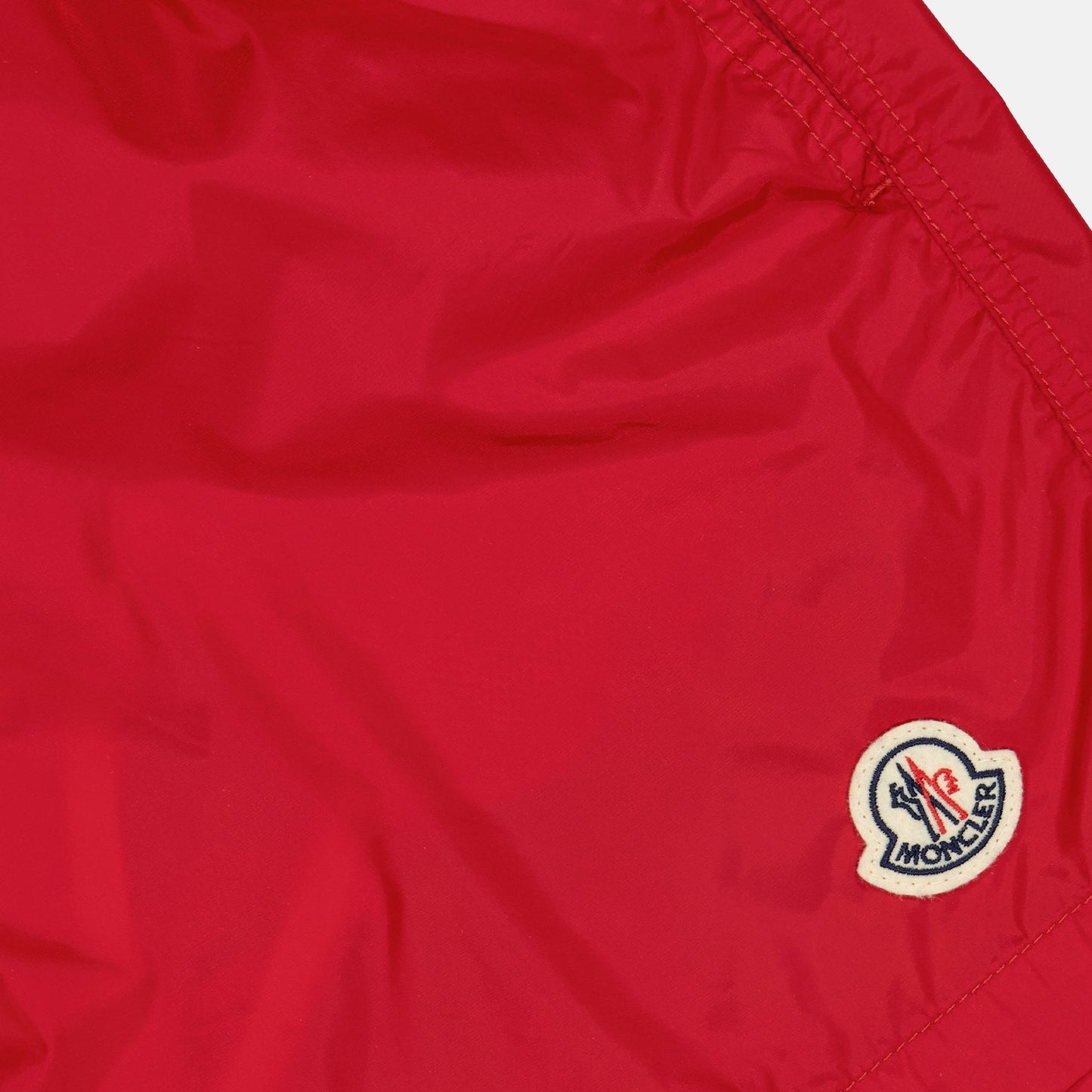 red logo swim shorts, Moncler swimwear, luxury swim shorts, designer swimwear, summer essentials