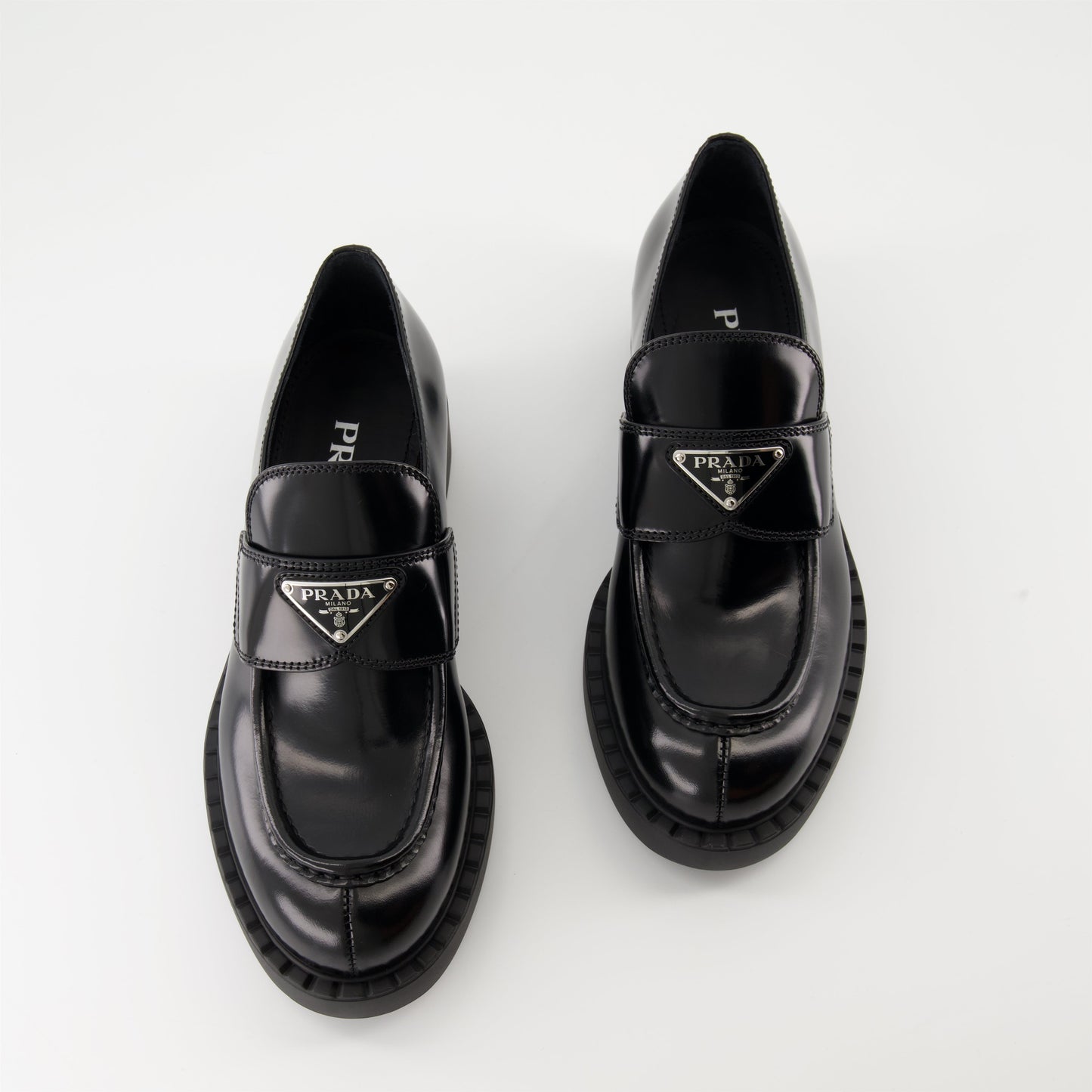 patent leather mocassins, luxury footwear, Prada AW24, black mocassins, elegant shoes