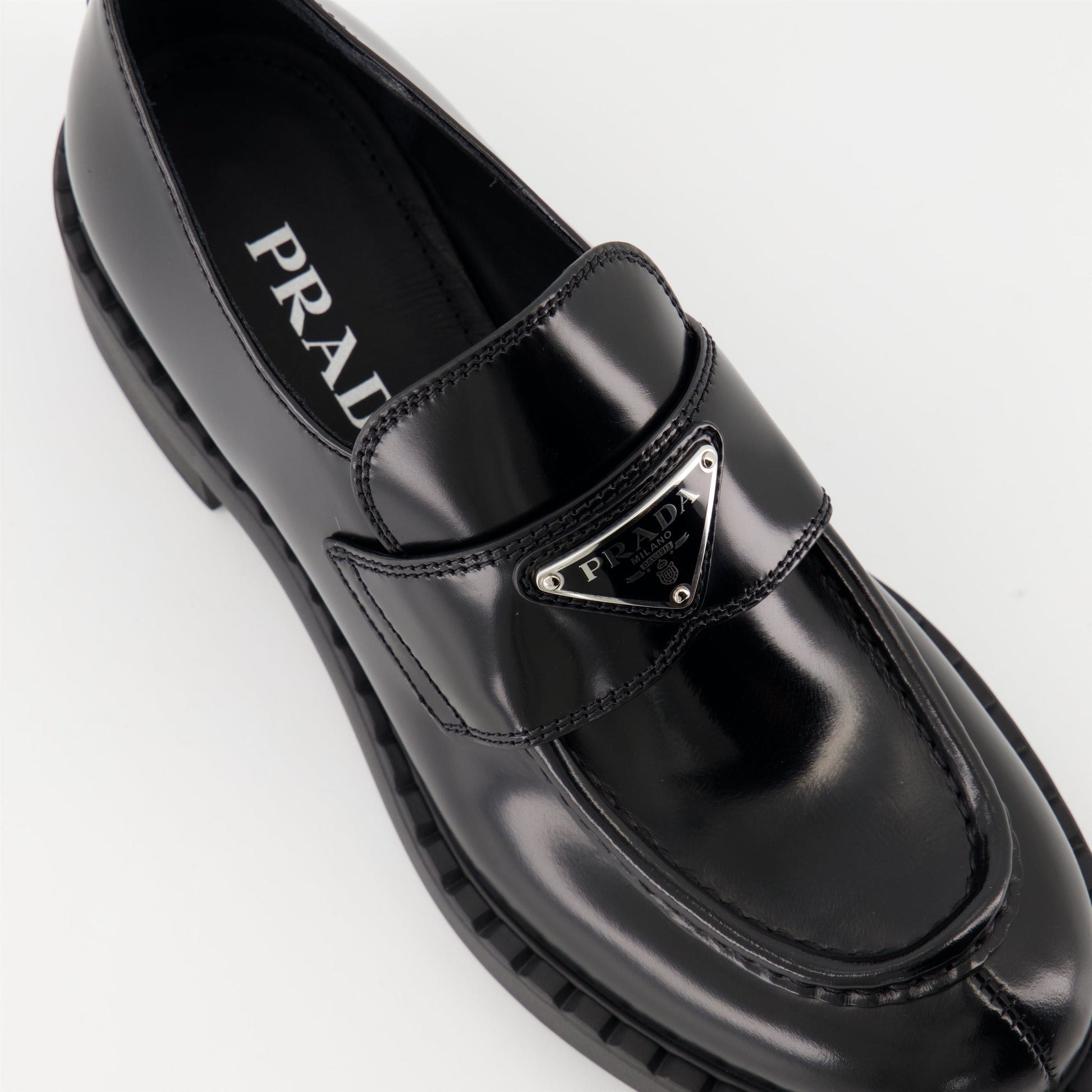 patent leather mocassins, luxury footwear, Prada AW24, black mocassins, elegant shoes