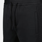 Oblique jogger pants, drawstring waist, embroidered logo, side motif, piped pockets
