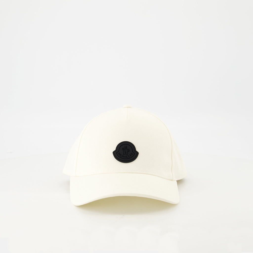 white cap, black logo, adjustable strap, high-quality cotton, contemporary design