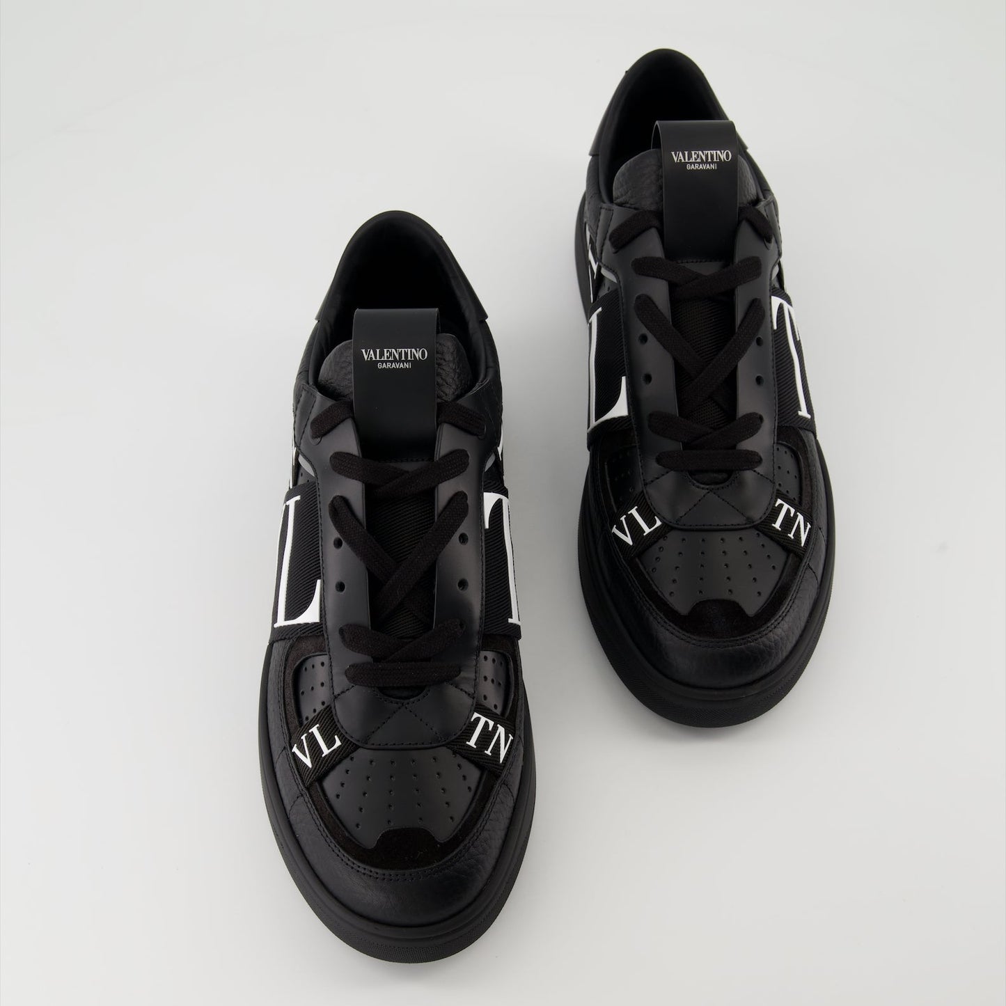 Valentino Garavani sneakers, black leather sneakers, luxury men's footwear, Autumn-Winter 2024 collection, premium grained leather