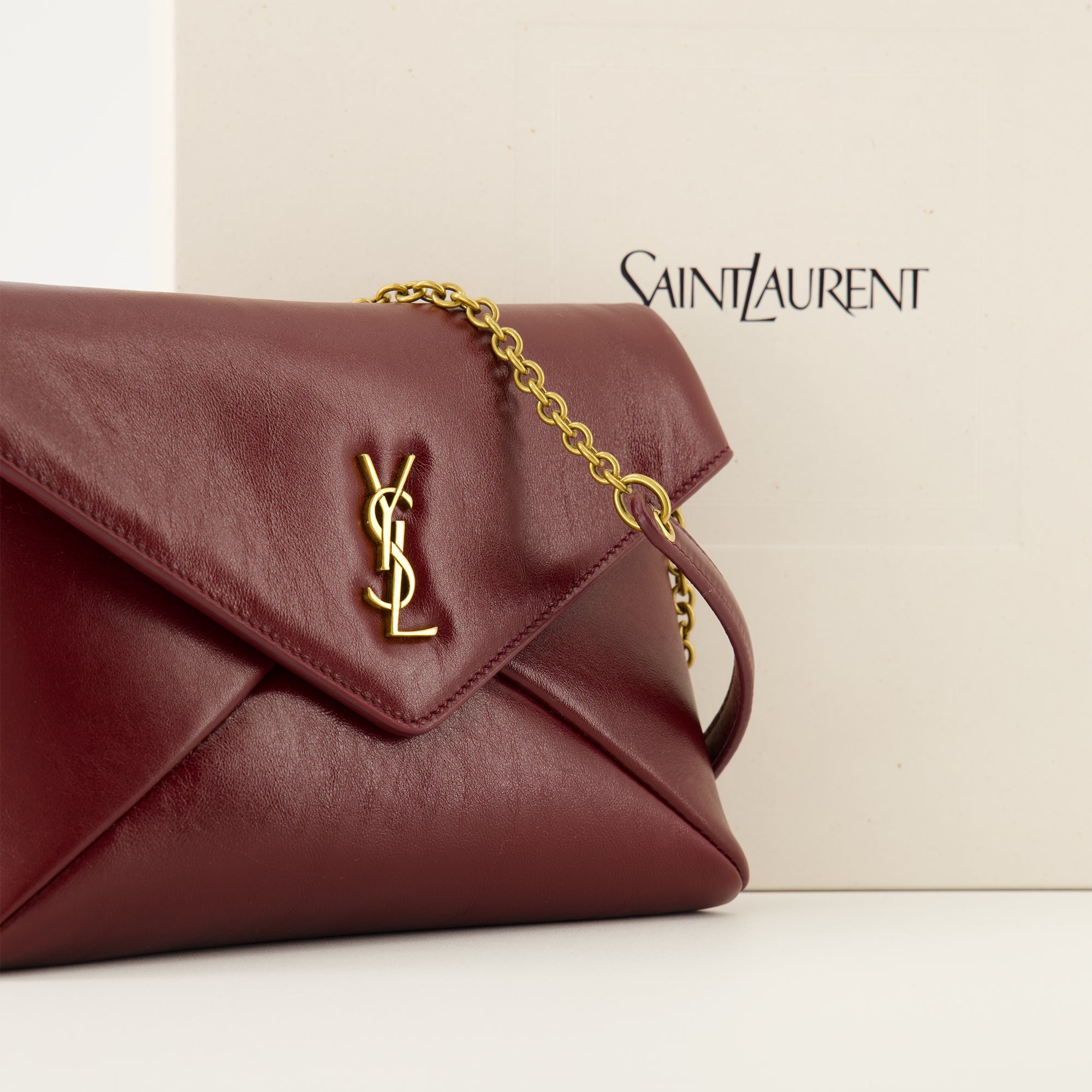 Saint Laurent pouch, red leather accessory, Cassandre design, high-quality leather bag, luxury fashion accessory