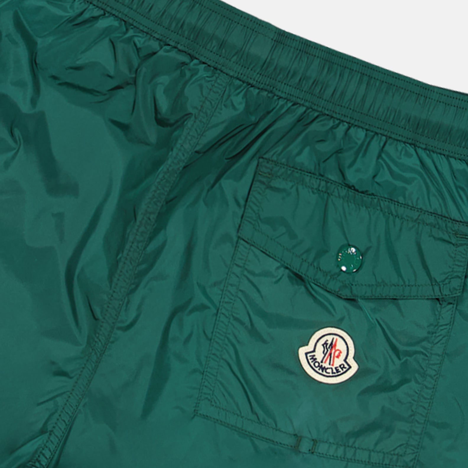 Moncler swim shorts, luxury swimwear, green swim shorts, premium beachwear, high-end swim attire