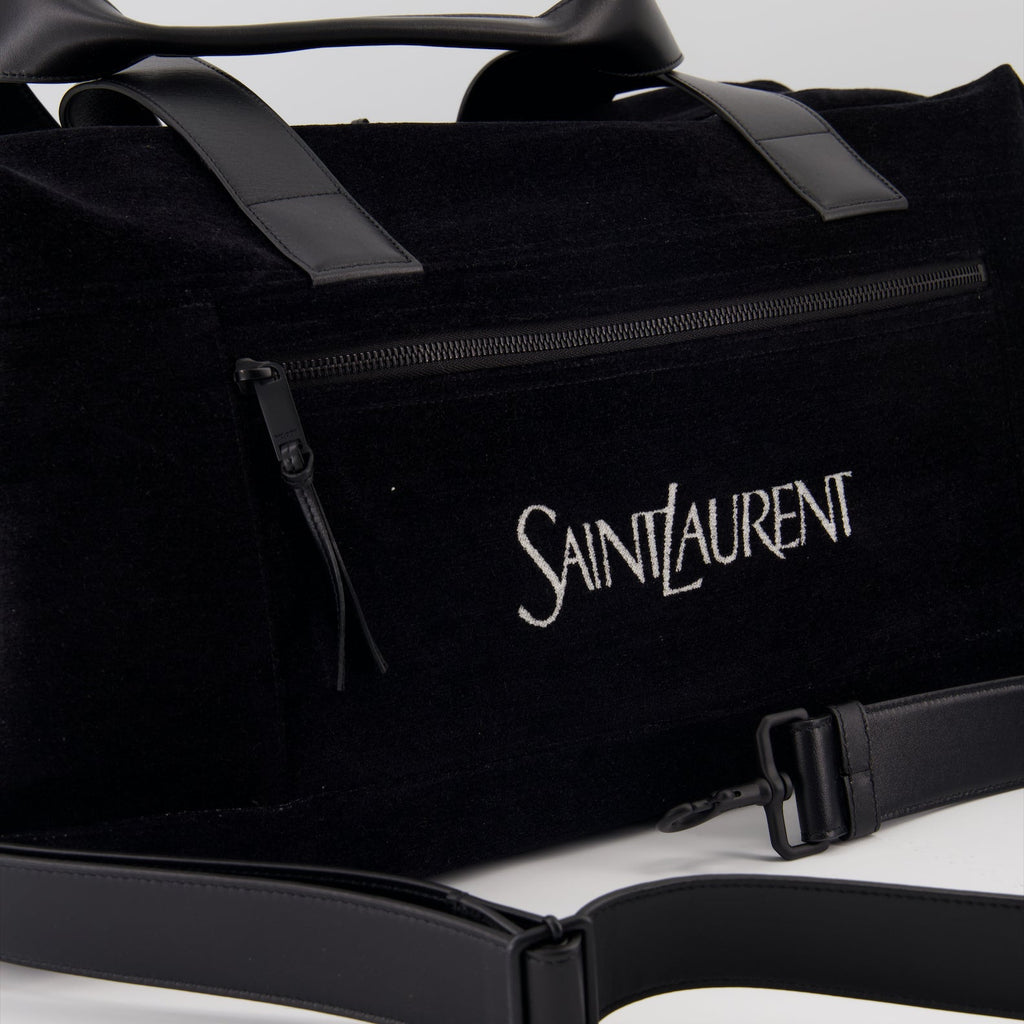elegant travel bag, black logo bag, luxury travel accessory, Saint Laurent bag, high-end travel gear