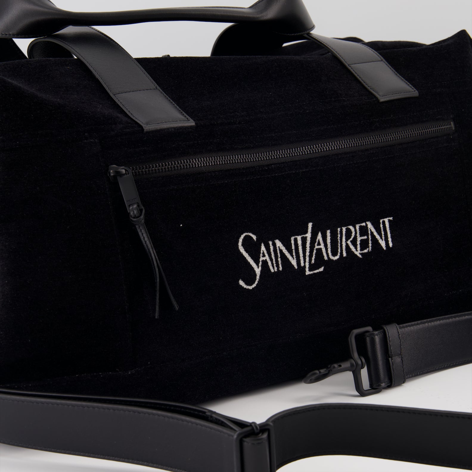 elegant travel bag, black logo bag, luxury travel accessory, Saint Laurent bag, high-end travel gear