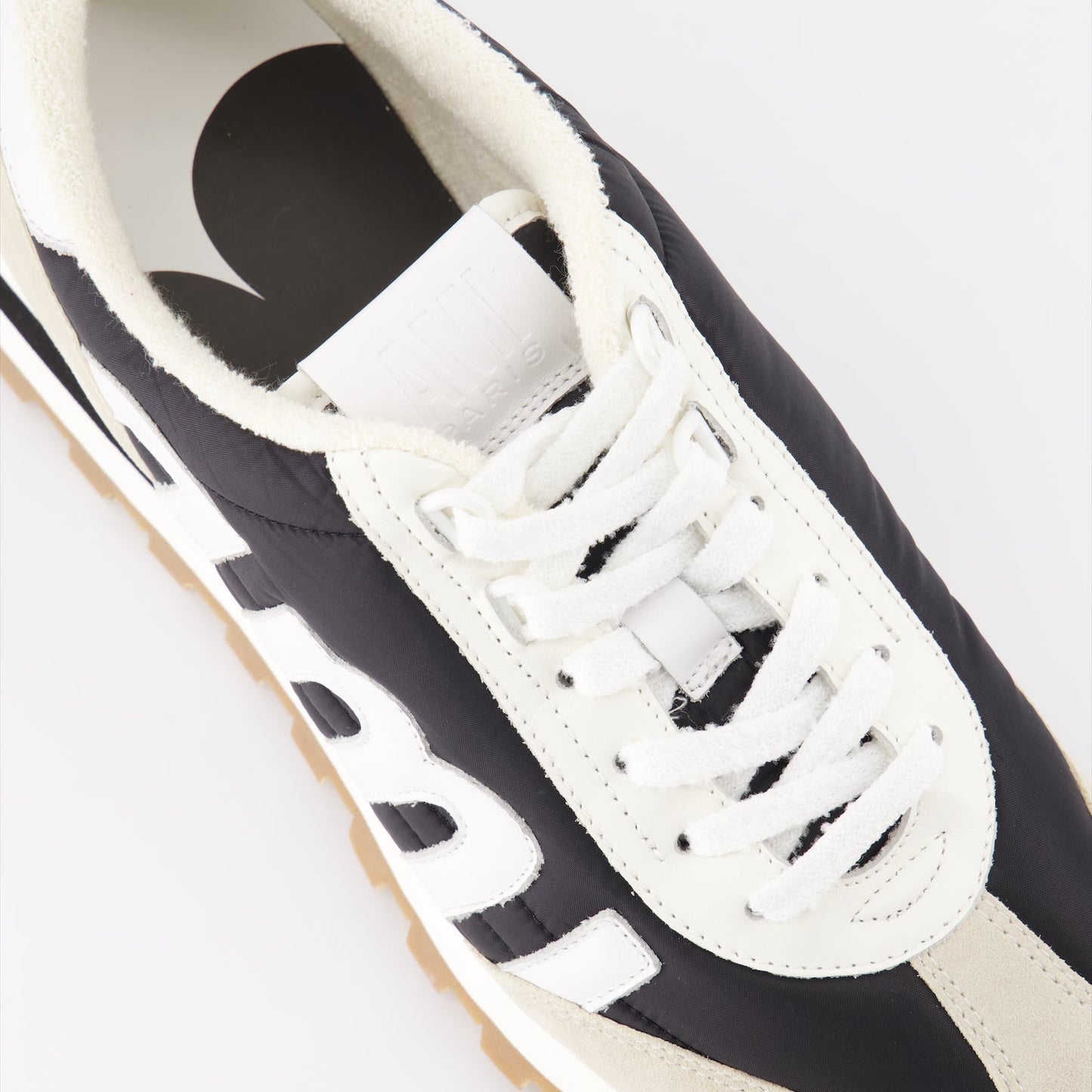 AMI Paris sneakers, unisex luxury sneakers, nylon sneakers, high-end footwear, contemporary fashion