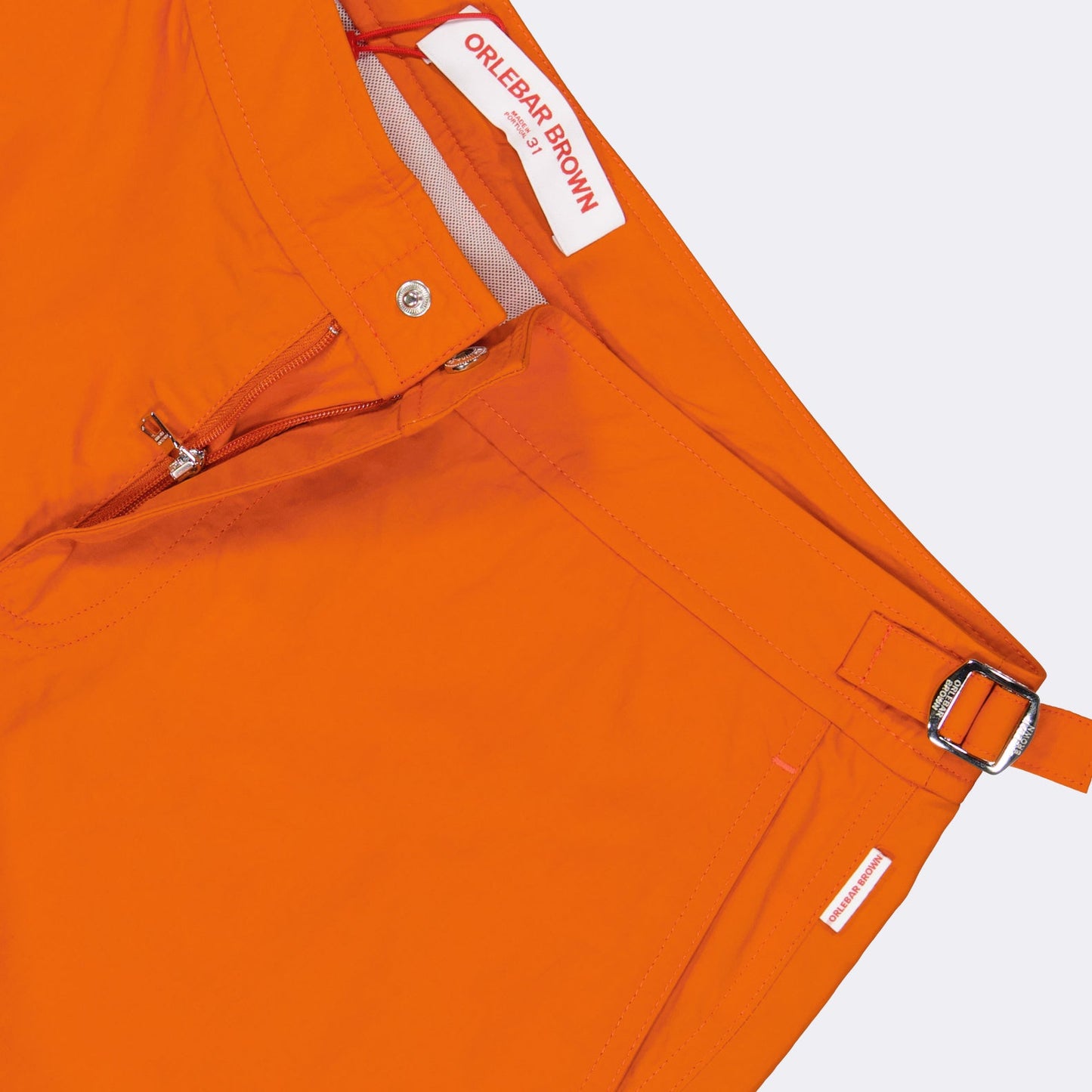 luxury swim shorts, designer swimwear, Orlebar Brown, high-end swim shorts, orange swim shorts