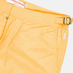Orlebar Brown swim shorts, luxury swimwear men, orange swim shorts, designer beachwear, high-end men’s fashion