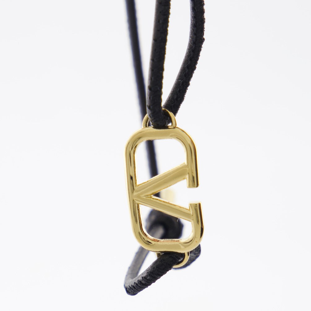 VLogo bracelet, black cord bracelet, adjustable bracelet, Valentino Garavani accessory, gold accents bracelet