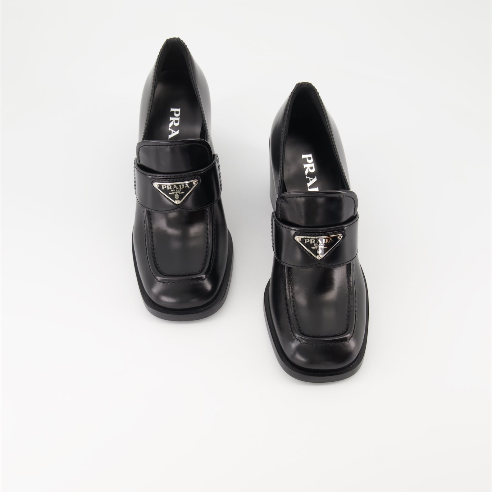 Prada leather moccasins, high-heeled moccasins, women's luxury shoes, polished leather footwear, designer moccasins