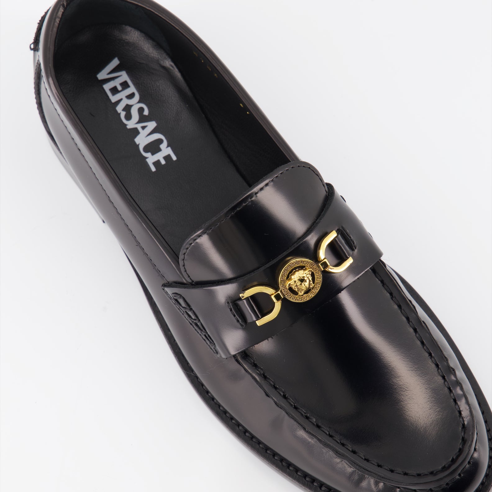 Versace moccasins, luxury women's footwear, Medusa emblem shoes, black leather moccasins, high-end women's shoes