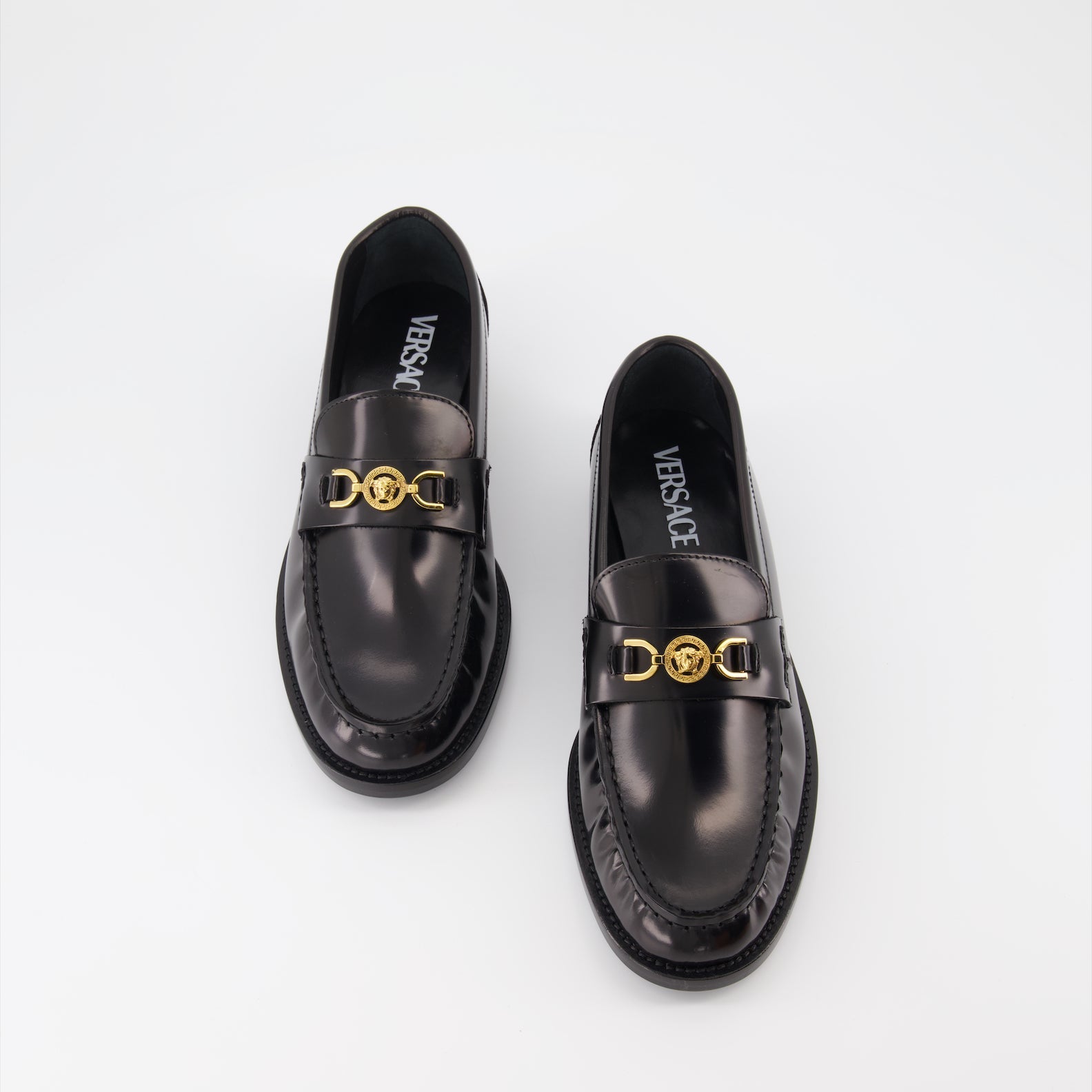 Versace moccasins, luxury women's footwear, Medusa emblem shoes, black leather moccasins, high-end women's shoes