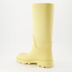 1. Luxury rain boots2. Yellow rubber boots3. Burberry footwear4. Fashionable rain gear5. Designer rain boots