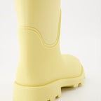 1. Luxury rain boots2. Yellow rubber boots3. Burberry footwear4. Fashionable rain gear5. Designer rain boots