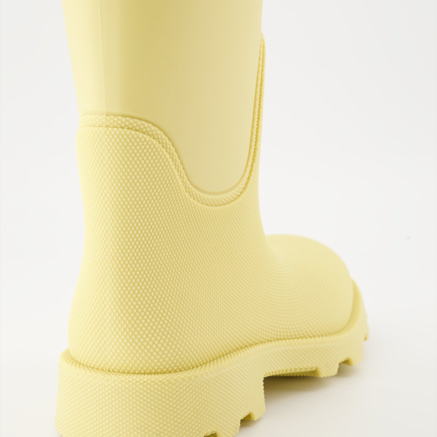 1. Luxury rain boots2. Yellow rubber boots3. Burberry footwear4. Fashionable rain gear5. Designer rain boots