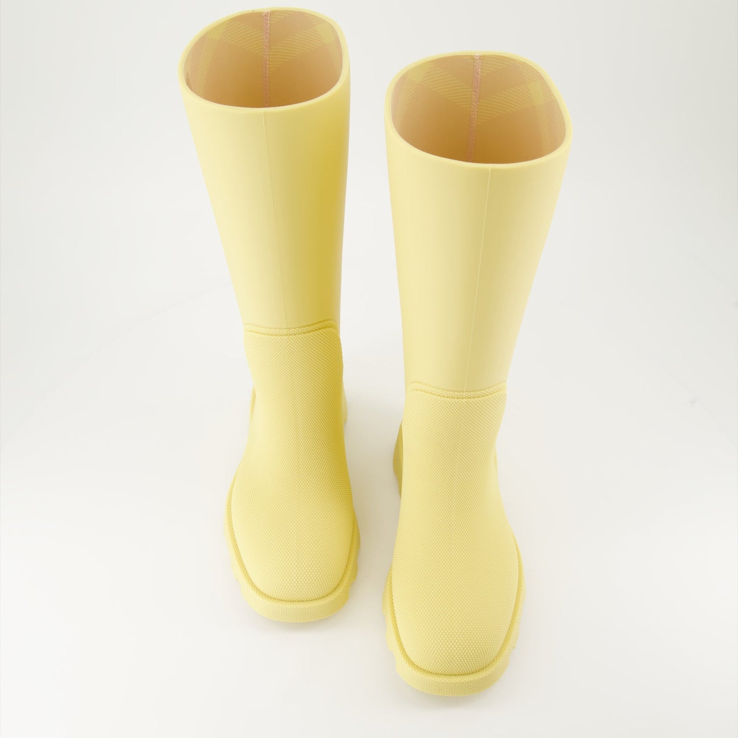 1. Luxury rain boots2. Yellow rubber boots3. Burberry footwear4. Fashionable rain gear5. Designer rain boots