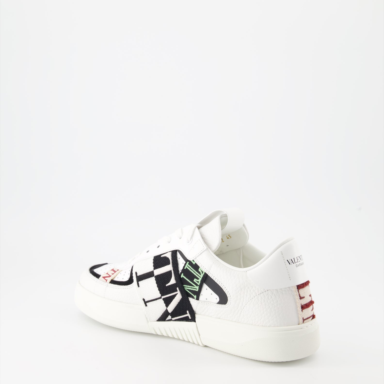 Valentino Garavani sneakers, luxury leather sneakers, white sneakers with black details, designer footwear, high-end fashion sneakers