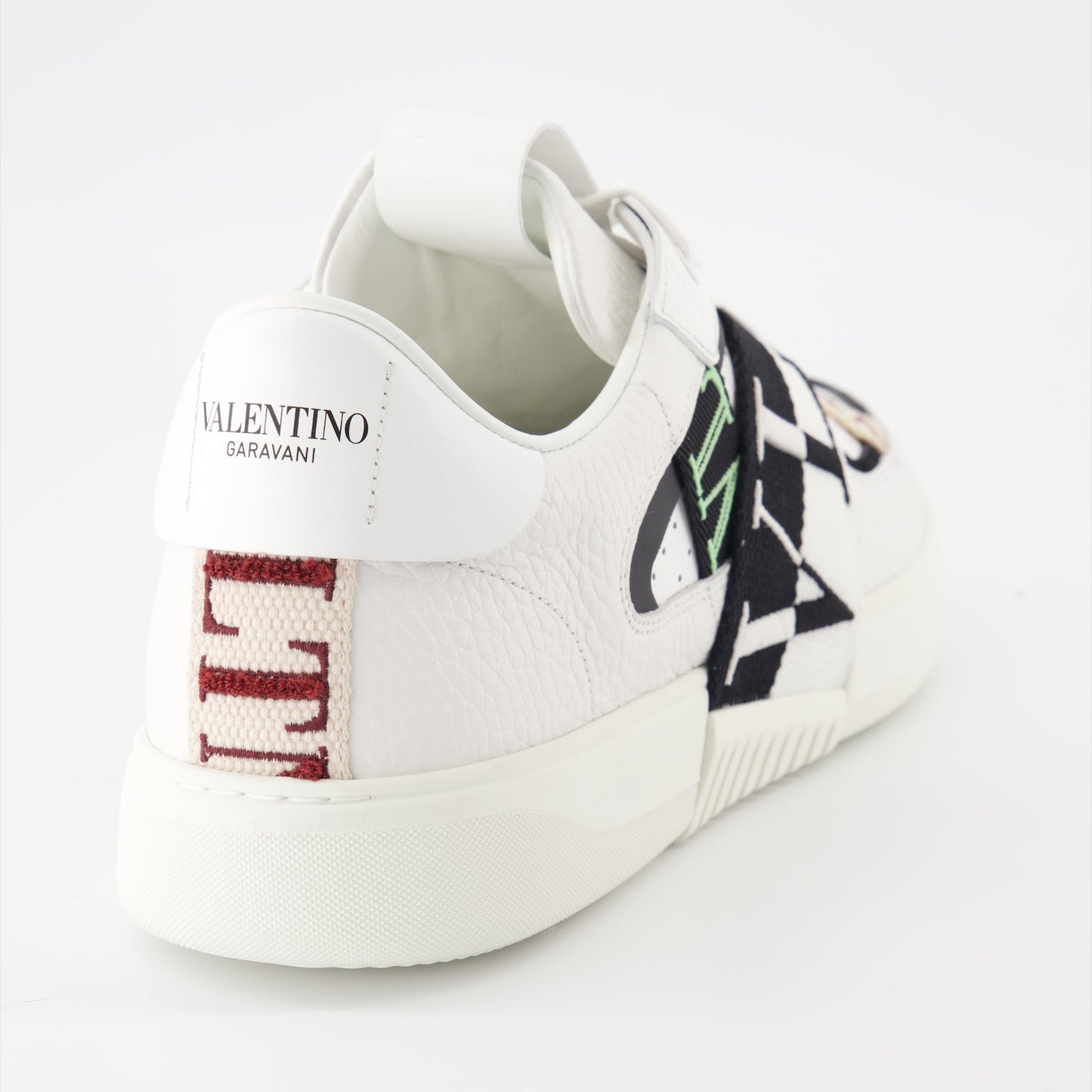 Valentino Garavani sneakers, luxury leather sneakers, white sneakers with black details, designer footwear, high-end fashion sneakers