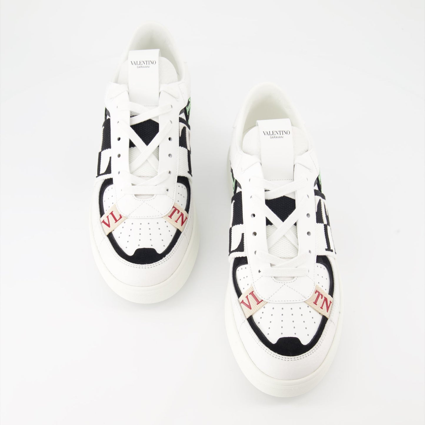 Valentino Garavani sneakers, luxury leather sneakers, white sneakers with black details, designer footwear, high-end fashion sneakers