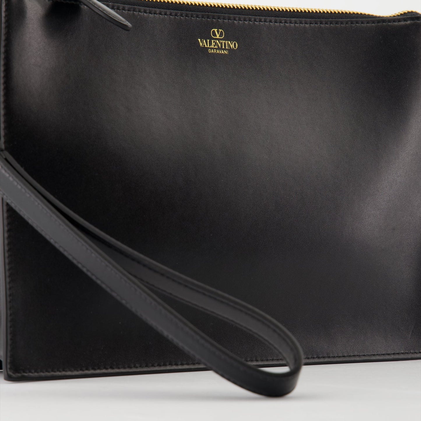 luxury leather clutch, Valentino Garavani, smooth leather accessory, high-end fashion, sophisticated clutch