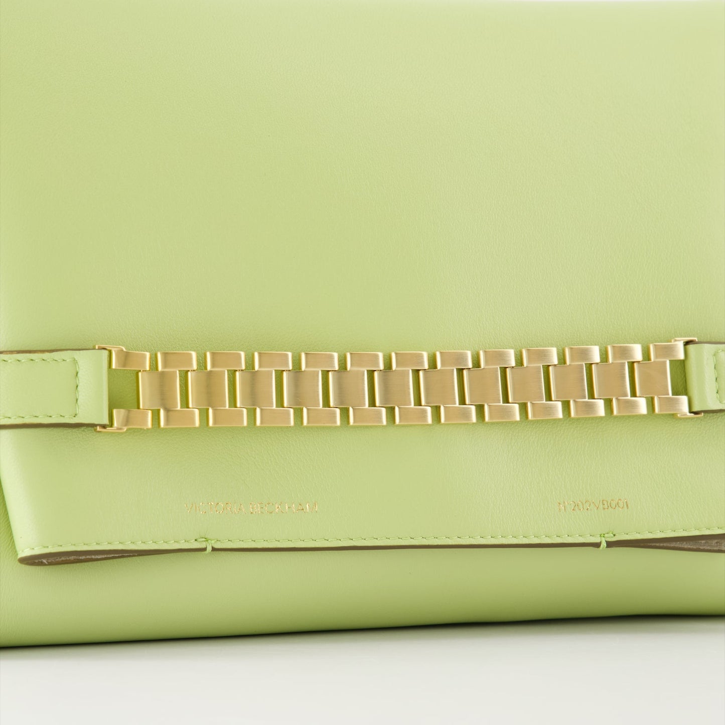 Victoria Beckham, green leather pochette, chain strap bag, luxury accessory, designer handbag