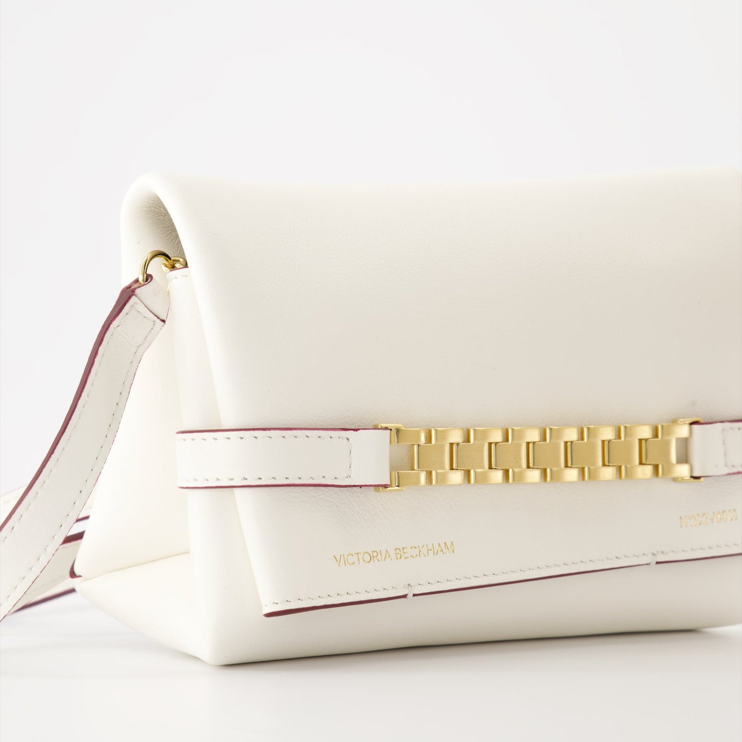 White leather pochette, luxury chain bag, Victoria Beckham accessories, elegant white clutch, high-end fashion