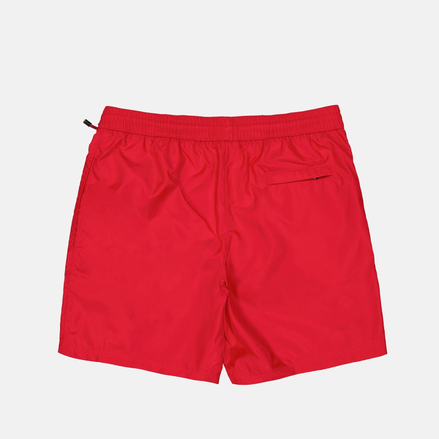 red swim shorts, luxury swimwear, Dolce & Gabbana, logo plaque swim shorts, designer swimwear