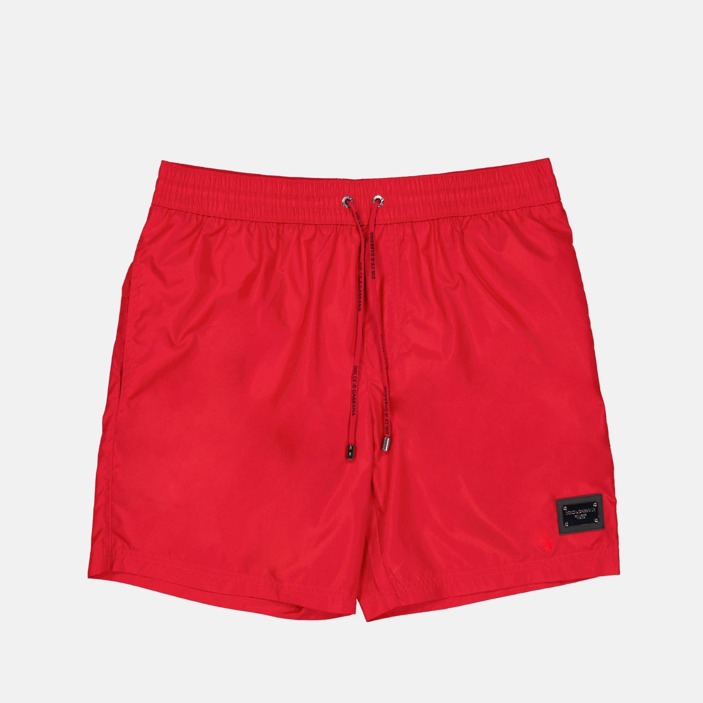 red swim shorts, luxury swimwear, Dolce & Gabbana, logo plaque swim shorts, designer swimwear