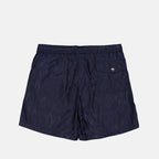 Monogrammed swim shorts, luxury men's swimwear, Moncler swim shorts, designer beachwear, high-end swimwear