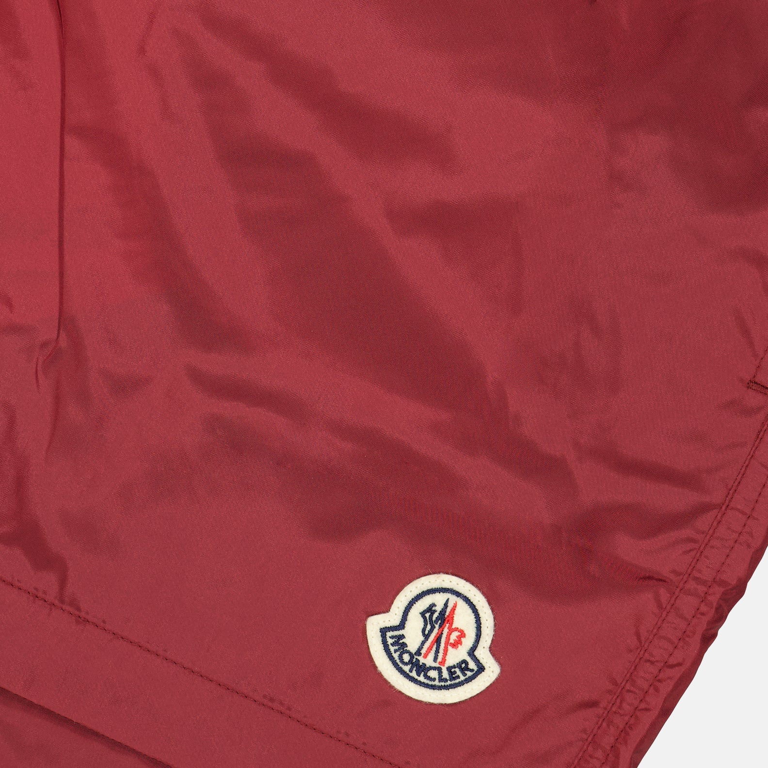 moncler swim shorts, burgundy logo shorts, luxury swimwear, premium swim shorts, high-end beachwear