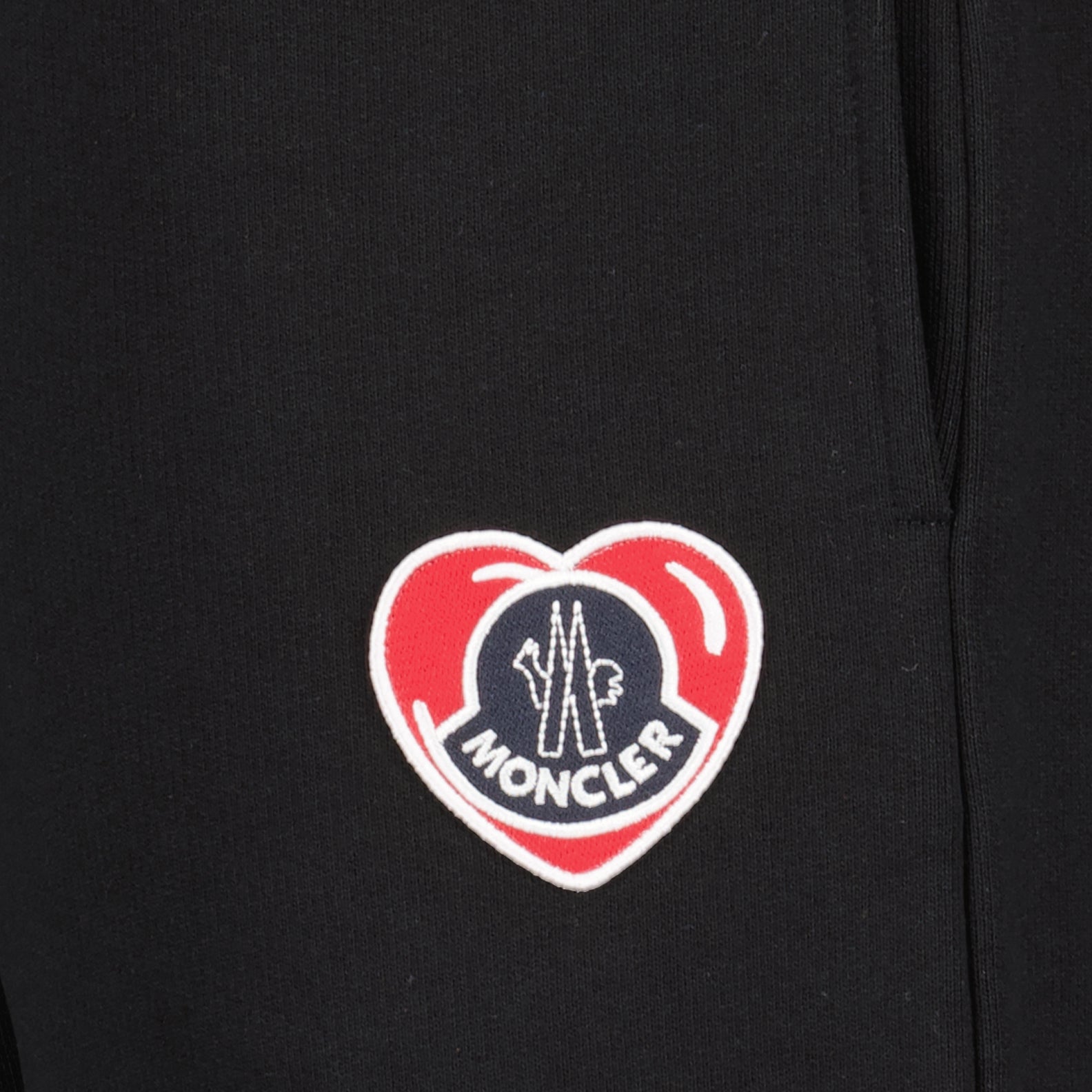 luxury jogging pants, black jogging pants, Moncler heart logo, designer casual wear, high-end fashion pants