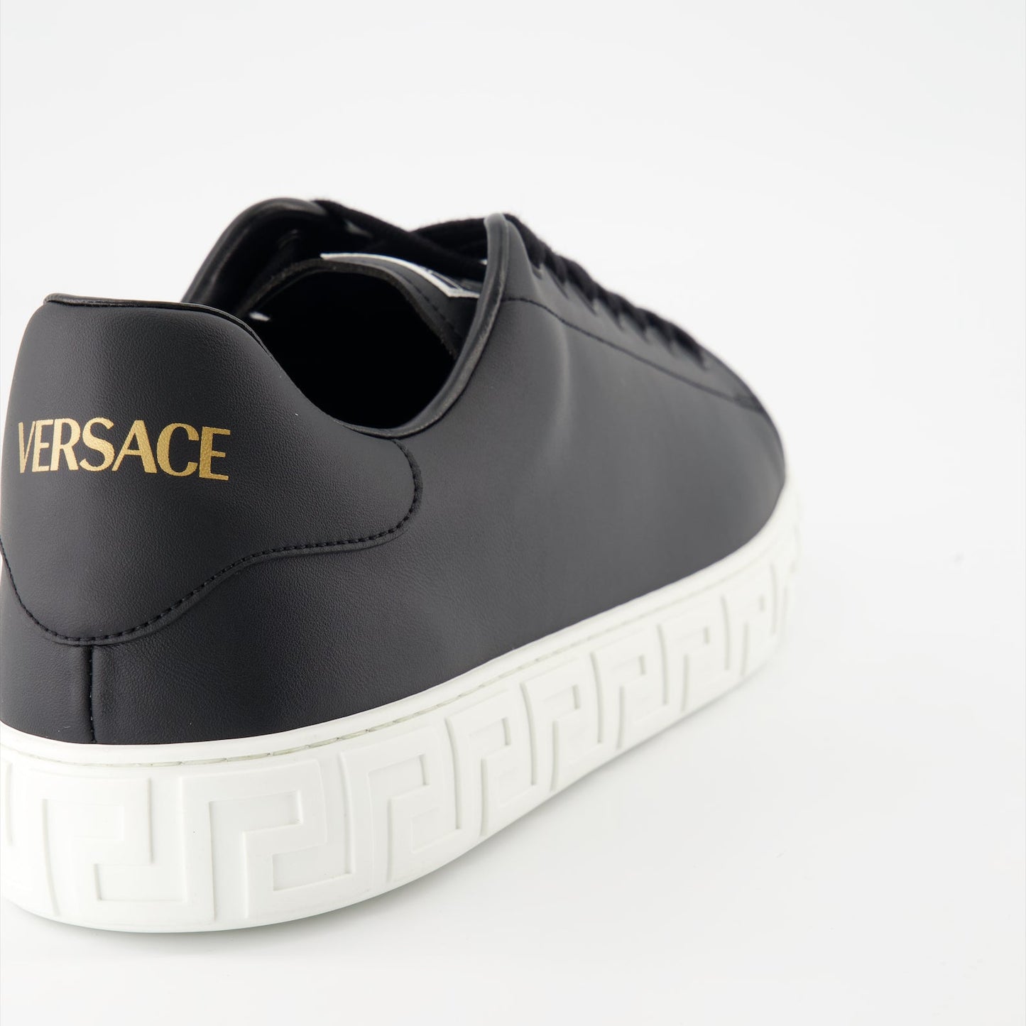 Versace sneakers, luxury footwear, Greca pattern shoes, black designer sneakers, high-end casual shoes