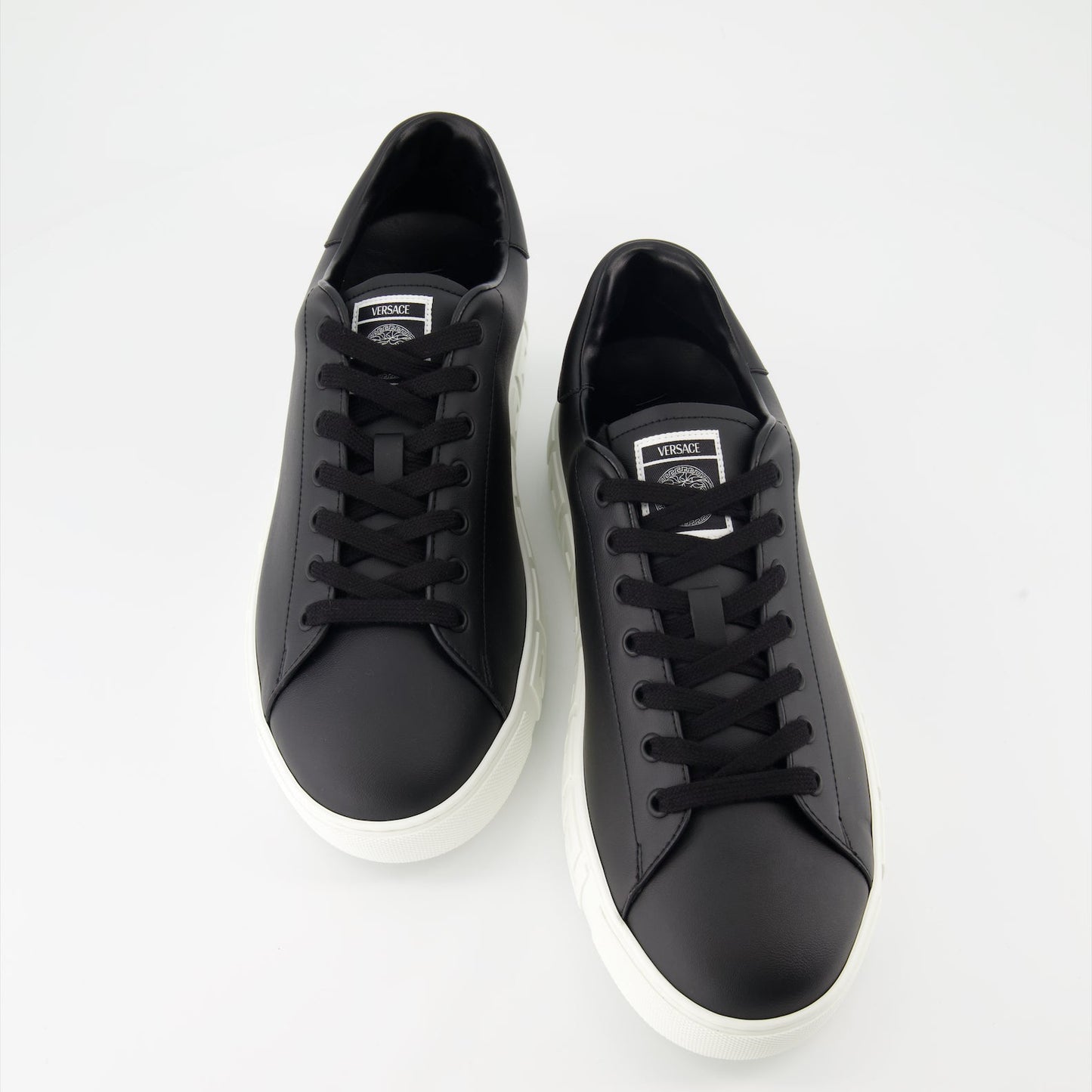 Versace sneakers, luxury footwear, Greca pattern shoes, black designer sneakers, high-end casual shoes