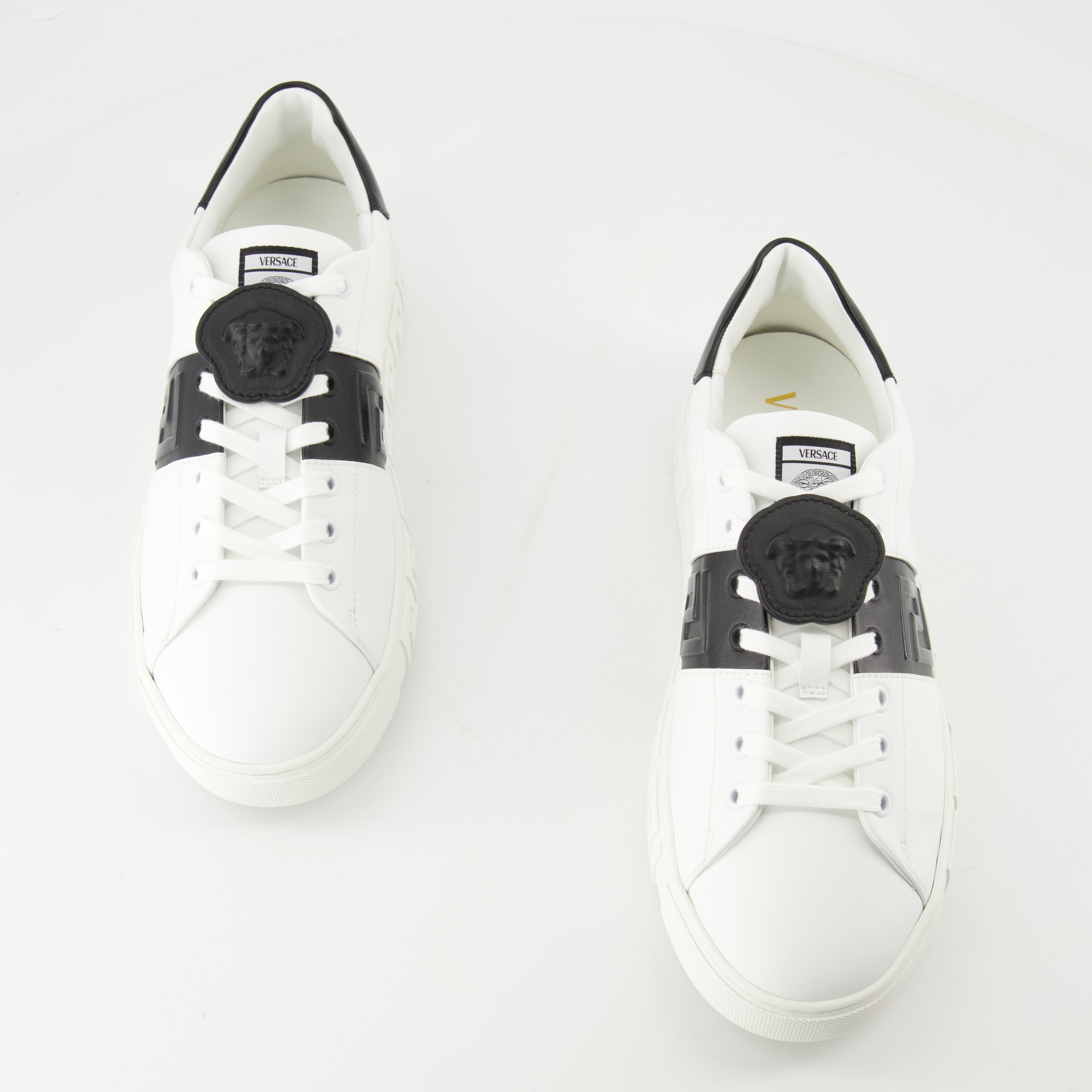 Versace sneakers, Greca design, black and white sneakers, smooth leather footwear, luxury casual shoes