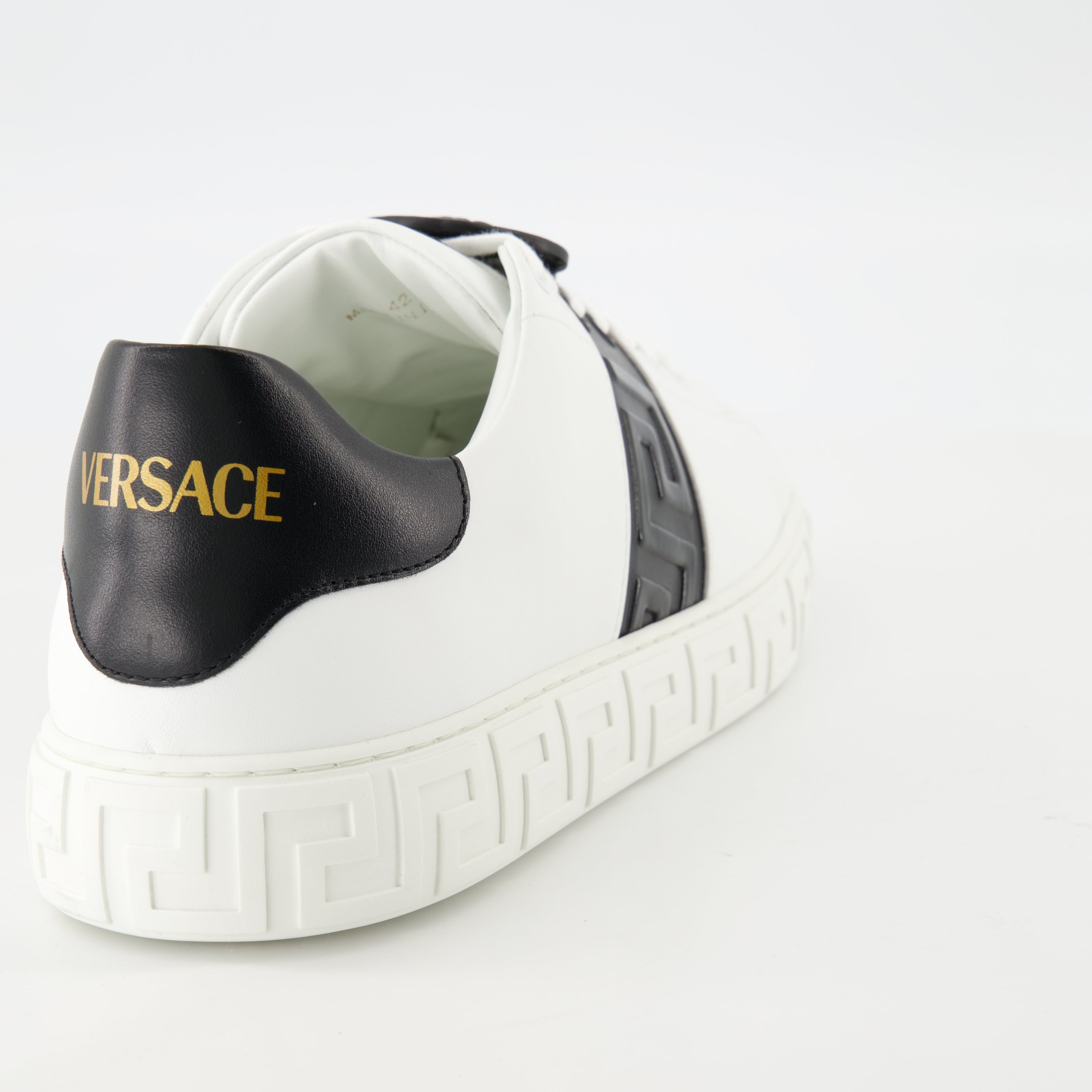 Versace sneakers, Greca design, black and white sneakers, smooth leather footwear, luxury casual shoes