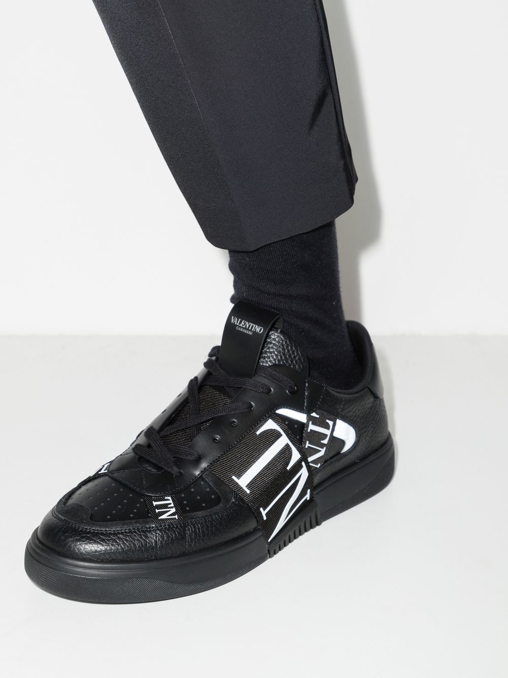 Valentino Garavani sneakers, black leather sneakers, luxury men's footwear, Autumn-Winter 2024 collection, premium grained leather