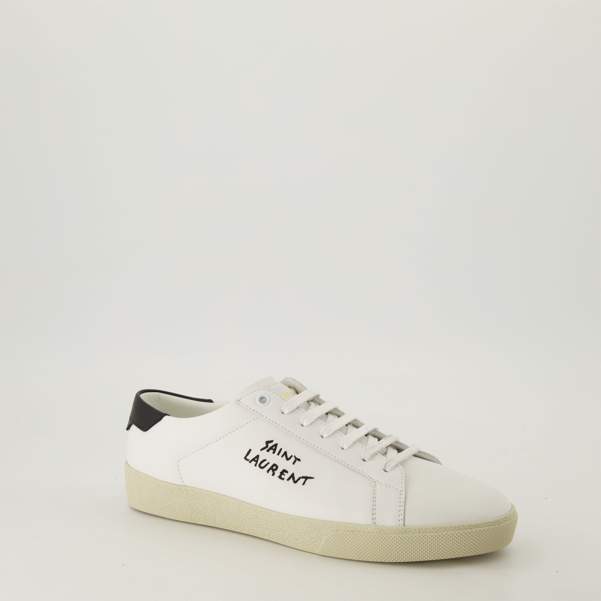 smooth leather sneakers, round toe design, gum sole sneakers, white leather sneakers, logo accent shoes