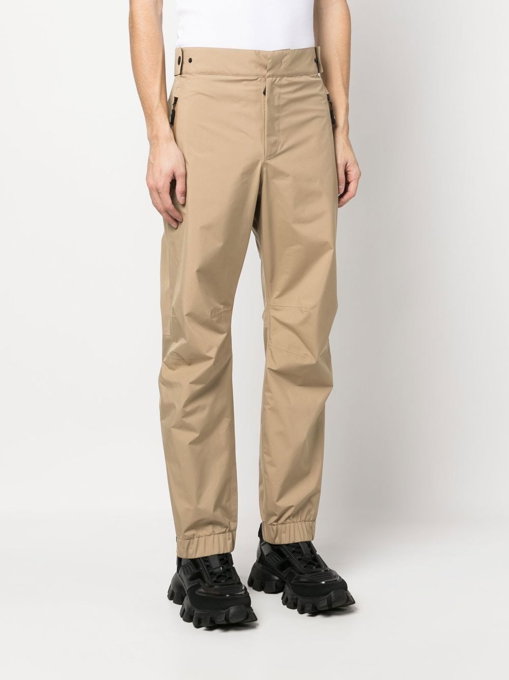  
Moncler Grenoble ski pants, luxury ski wear, beige ski pants, men's ski pants, high-end ski apparel  
**