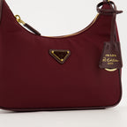 Prada Mini Sac, Re-Edition 2005, bordeaux handbag, recycled materials, sustainable fashion