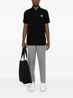 Image of Black Piqué Cotton Polo by Moncler for Men - Season Autumn-Winter 2025 - Model view 1