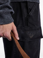 Image of Black Distressed Cargo Pants by Prada for Men - Season Spring-Summer 2025 - Model view 4