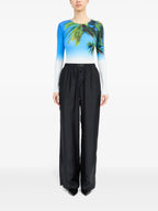 Image of Black Silk Pants with Elastic Waist by Mm6 for Women - Season Spring-Summer 2025 - Model view 1