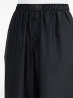 Image of Black Silk Pants with Elastic Waist by Mm6 for Women - Season Spring-Summer 2025 - Model view 6