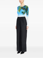 Image of Black Silk Pants with Elastic Waist by Mm6 for Women - Season Spring-Summer 2025 - Model view 4