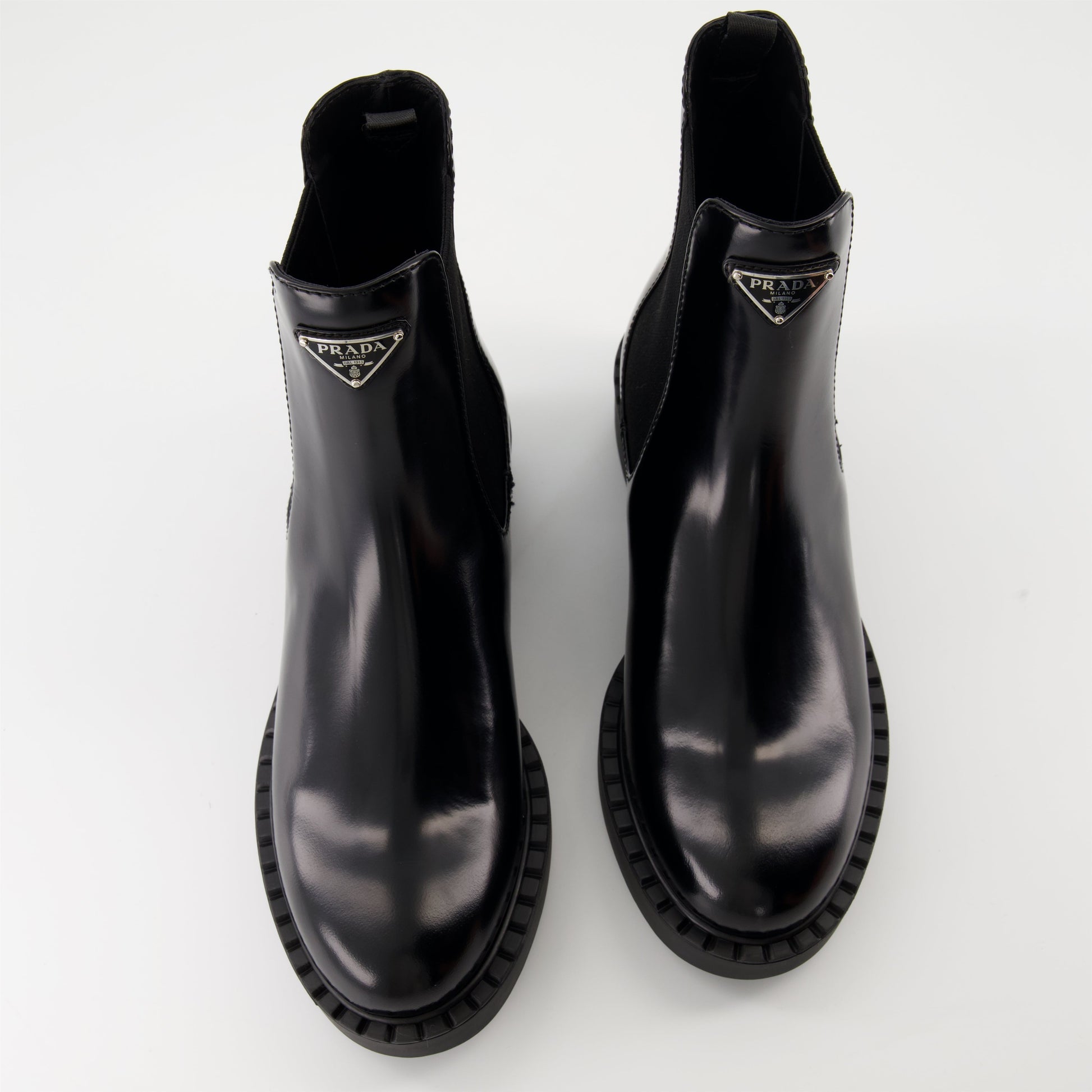   Patent leather boots, Prada ankle boots, black patent shoes, luxury footwear, autumn-winter collection.