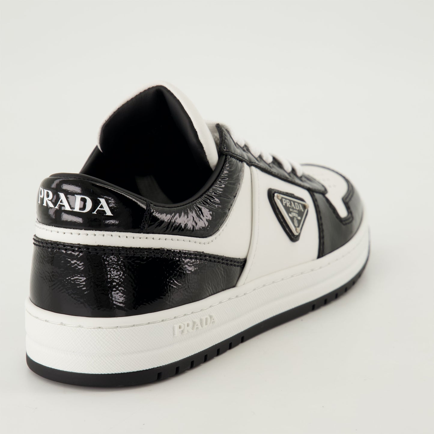 black patent sneakers, geometric tread pattern, lace-up design, removable leather insole, two-tone sneakers