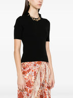 Image of Black wool sweater with gold chain by Rabanne for Women - Season Spring-Summer 2025 - Model view 2