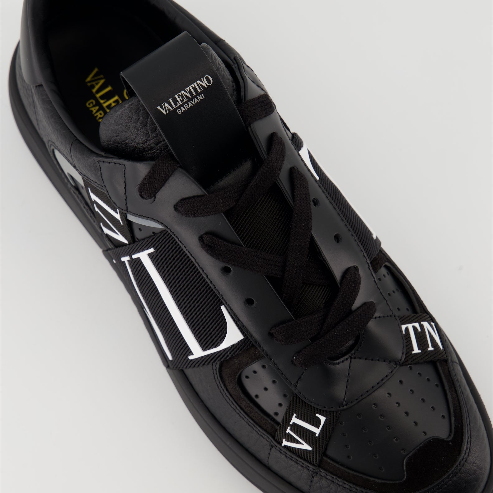 Valentino Garavani sneakers, black leather sneakers, luxury men's footwear, Autumn-Winter 2024 collection, premium grained leather